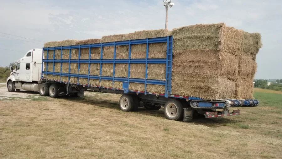 A Kelderman Self Loading Trailer with hay bales stacked from front to back